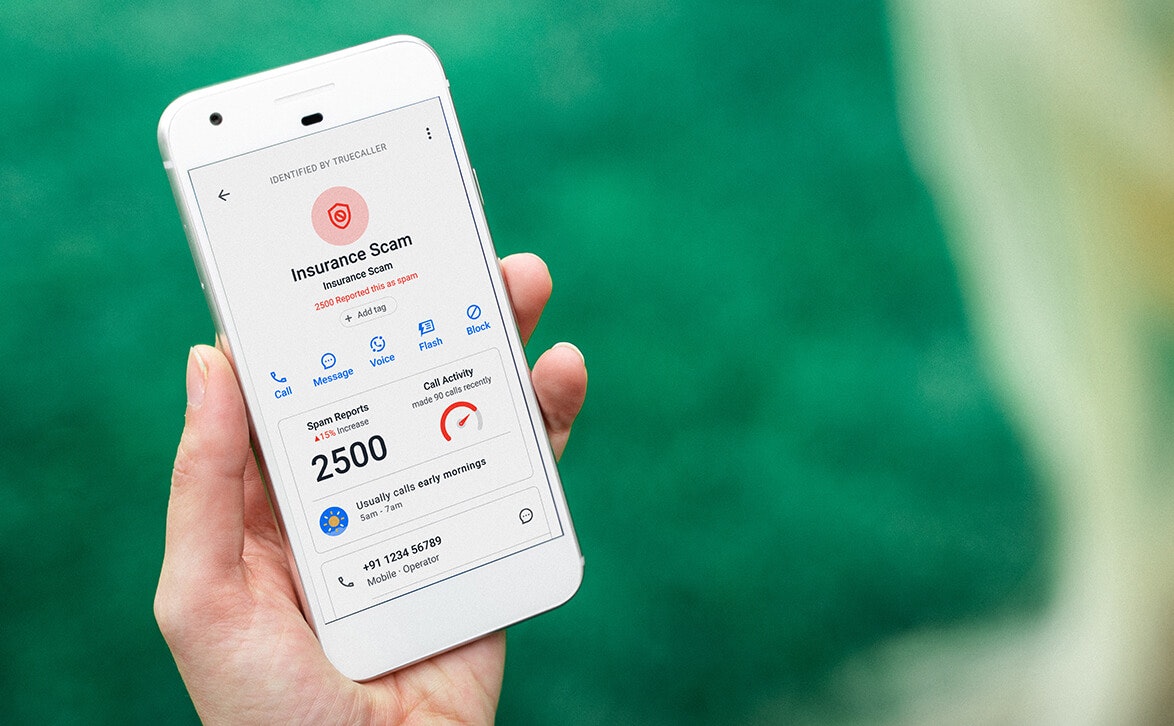 someone holding a phone showing the tab for spam statistics for a specific spammer in the truecaller app