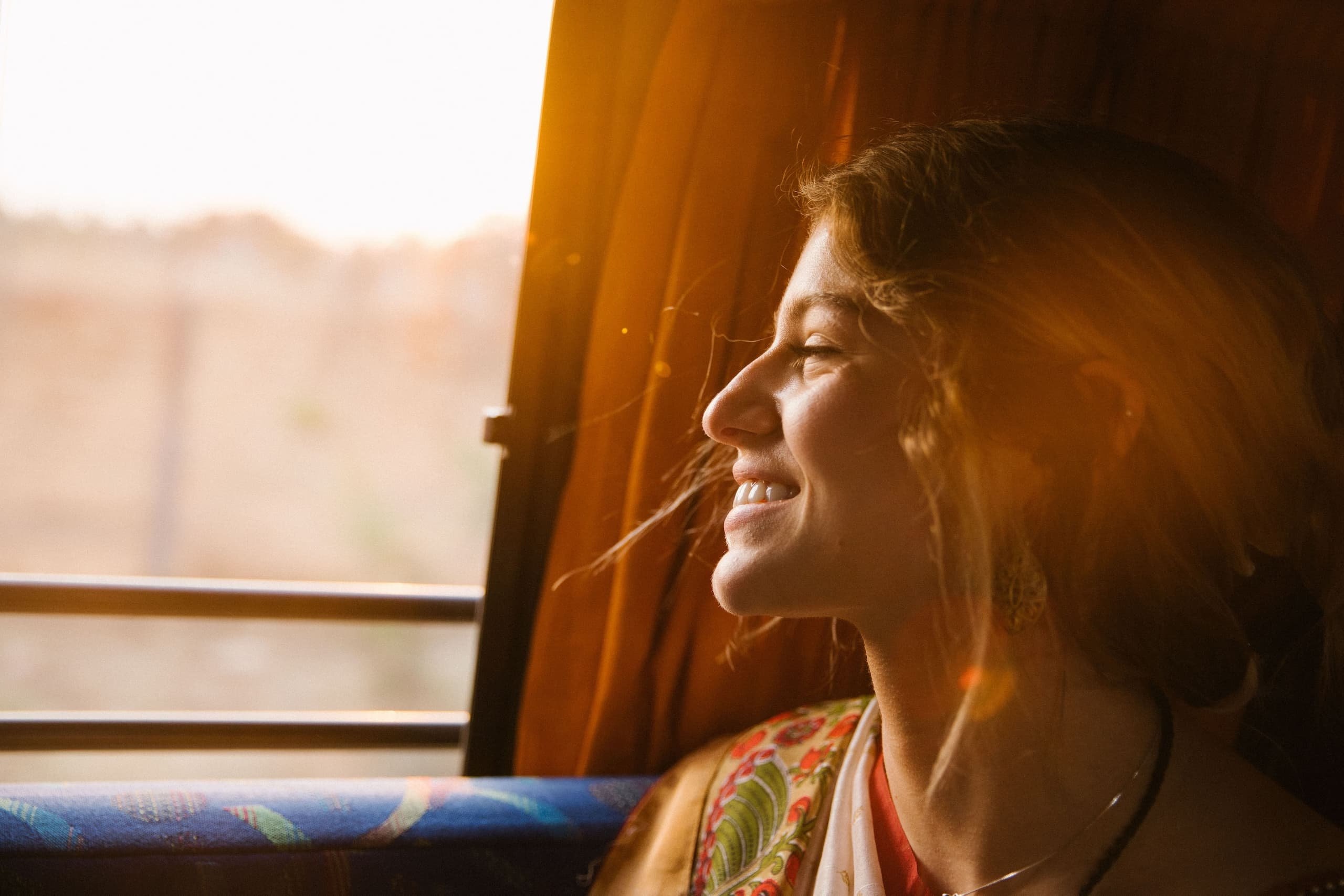 woman looking out the window smiling